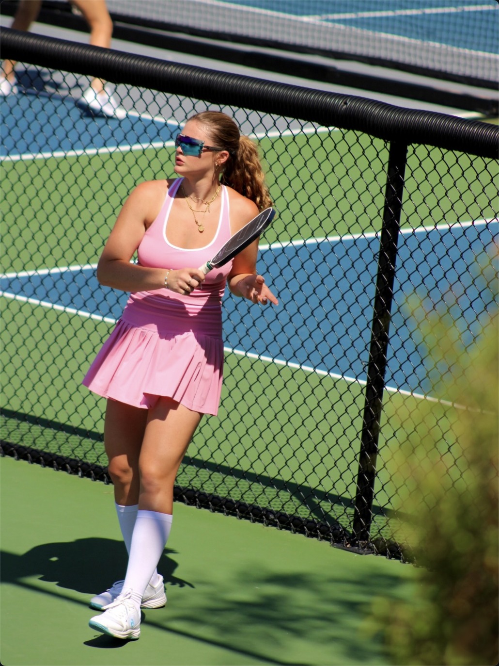Cailyn Campbell in pink, paddle in hand on court