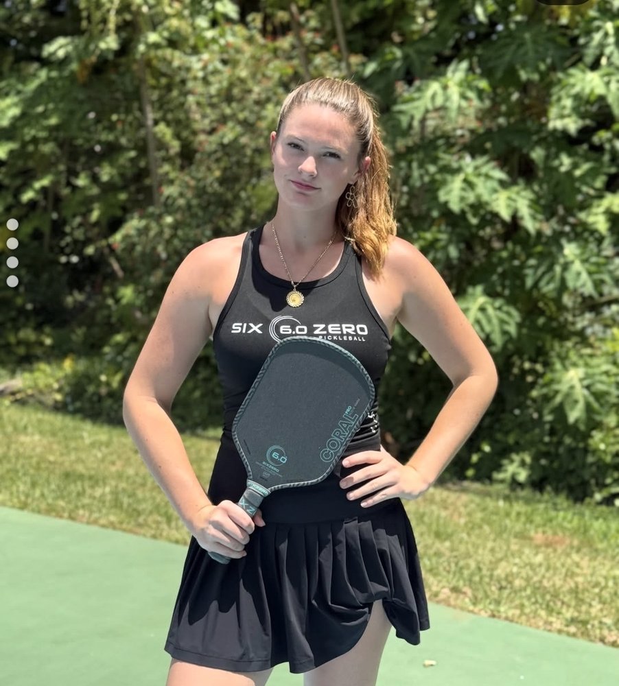 Cailyn Campbell in Six Zero Pickleball gear holding the Coral Pro paddle